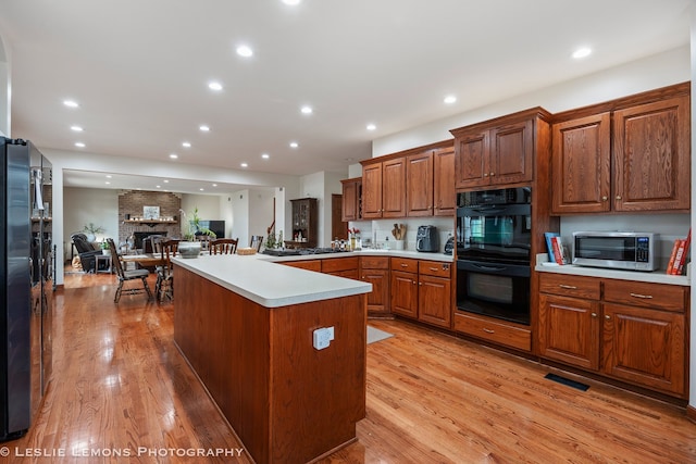 kitchen with light wood-style flooring, light countertops, recessed lighting, and stainless steel appliances