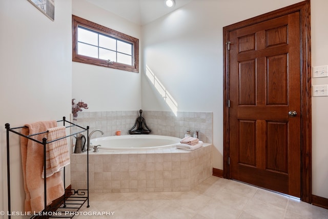 full bath featuring tile patterned floors and a garden tub
