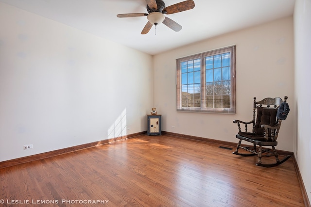 unfurnished room featuring wood finished floors, baseboards, a ceiling fan, and visible vents