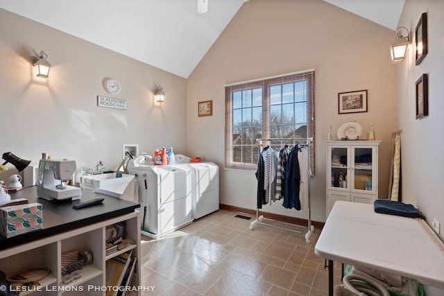 clothes washing area featuring baseboards, washer and dryer, a high ceiling, a sink, and laundry area