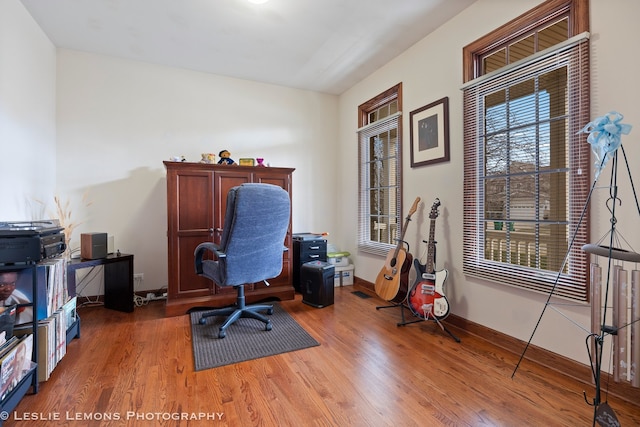 office area with light wood-style flooring and baseboards
