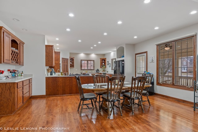 dining area featuring light wood-style floors, baseboards, and recessed lighting