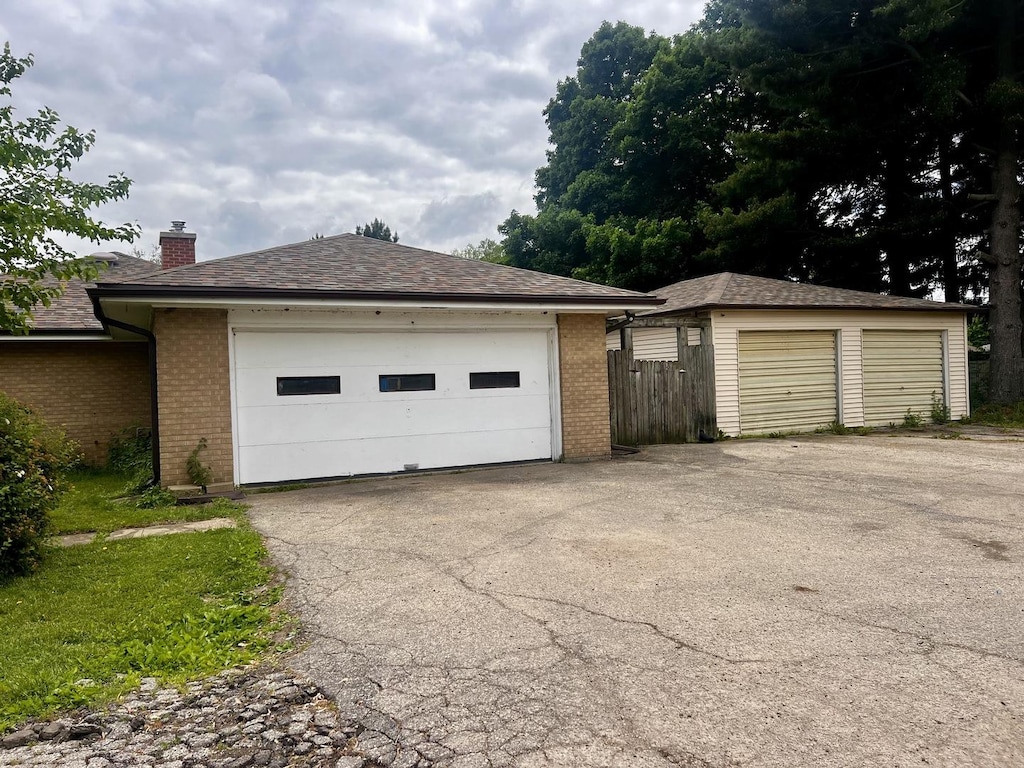 1320 N Il Rte 2, Oregon, IL 61061 - view of side of property with brick siding, an outbuilding, a chimney, and a detached garage