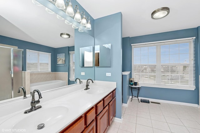 full bathroom with a bath, tile patterned floors, a sink, and baseboards