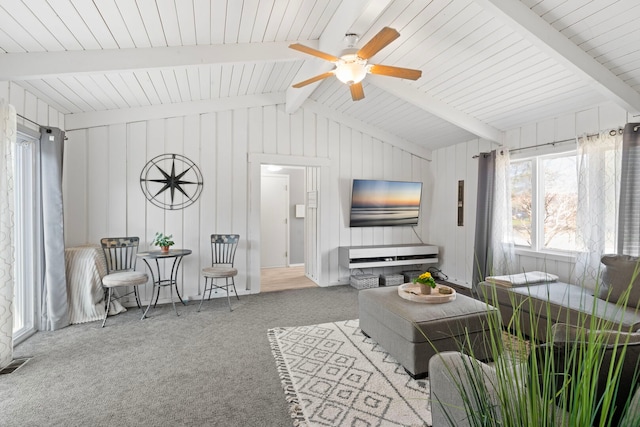 6802 Lyons St, Morton Grove, IL 60053 - carpeted living room with visible vents, vaulted ceiling with beams, and ceiling fan