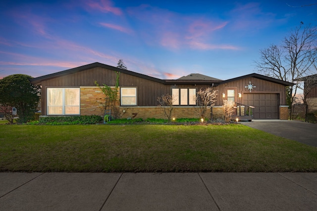 6802 Lyons St, Morton Grove, IL 60053 - view of front facade featuring brick siding, an attached garage, driveway, and a front lawn
