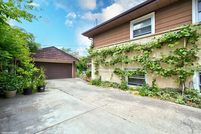 8936 N Elmore St, Niles, IL 60714 - view of side of property with brick siding, a detached garage, and an outbuilding