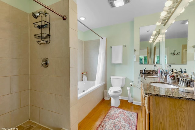 8936 N Elmore St, Niles, IL 60714 - full bathroom featuring wood finished floors, visible vents, toilet, a sink, and tiled shower / bath combo