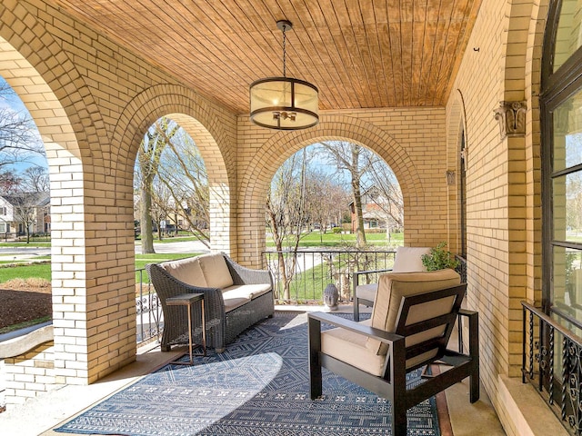 view of patio featuring covered porch and a water view