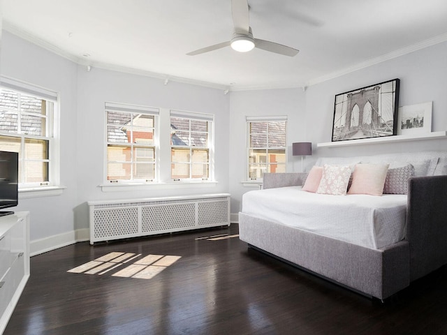 bedroom featuring radiator heating unit, ornamental molding, wood finished floors, baseboards, and a ceiling fan