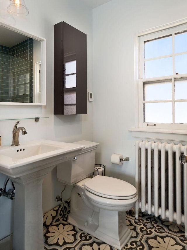 bathroom featuring radiator, toilet, and tile patterned floors