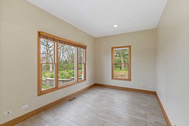 unfurnished room featuring baseboards, recessed lighting, and visible vents