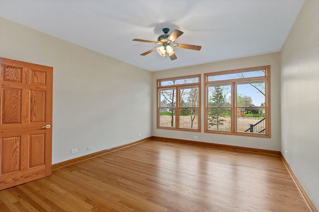 unfurnished room with baseboards, ceiling fan, and light wood finished floors