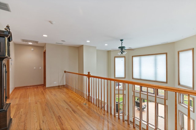 hall featuring recessed lighting, baseboards, visible vents, and light wood finished floors