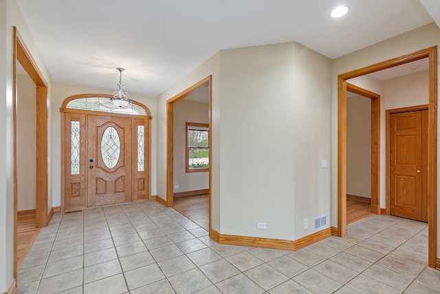 foyer entrance with visible vents, recessed lighting, baseboards, and light tile patterned flooring