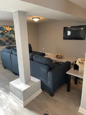 living area featuring light wood-style flooring and baseboards