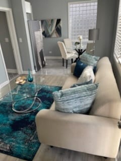 living area featuring baseboards and wood finished floors