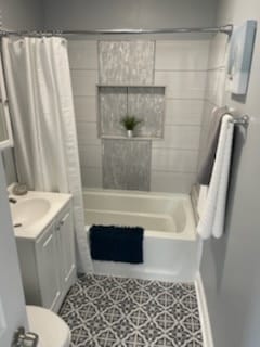 bathroom featuring shower / bath combination with curtain, vanity, and toilet