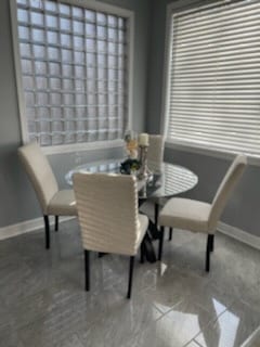 dining space with tile patterned floors and baseboards