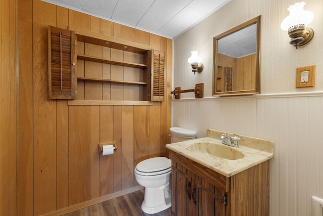 118 S Clarendon Ave, Addison, IL 60101 - bathroom with toilet, vanity, wood finished floors, wooden walls, and crown molding