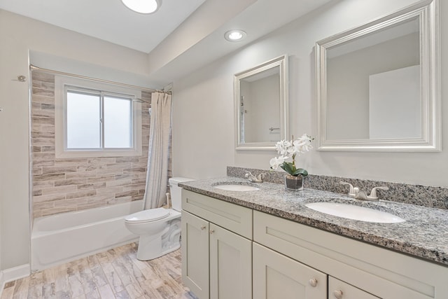 bathroom featuring a sink, toilet, shower / bathtub combination with curtain, and double vanity