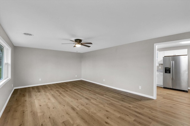 unfurnished room with visible vents, baseboards, a ceiling fan, and light wood finished floors