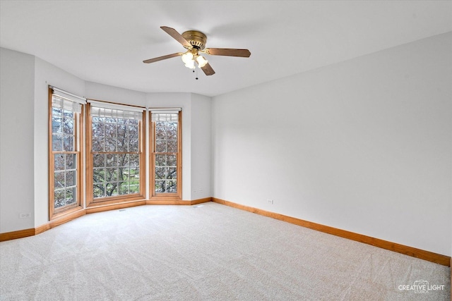 unfurnished room with carpet floors and baseboards