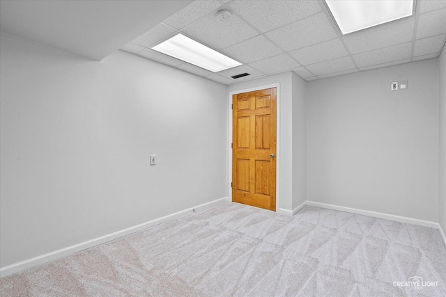 unfurnished room with baseboards, carpet floors, and a paneled ceiling