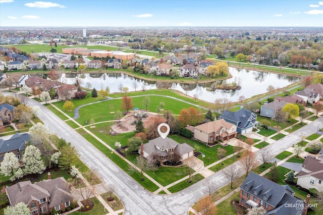drone / aerial view with a water view and a residential view
