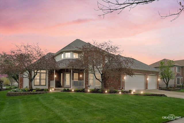 french country style house featuring a front yard, covered porch, brick siding, concrete driveway, and an attached garage