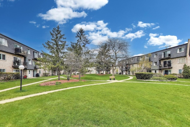 view of community featuring a yard and a residential view