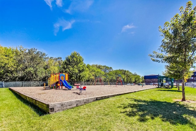 communal playground with a lawn and fence