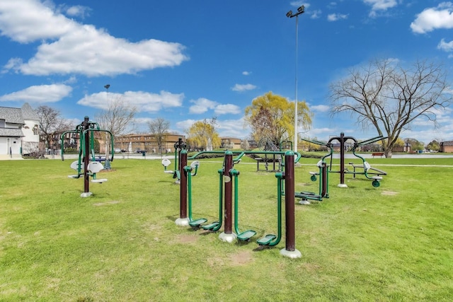 view of home's community with playground community and a yard