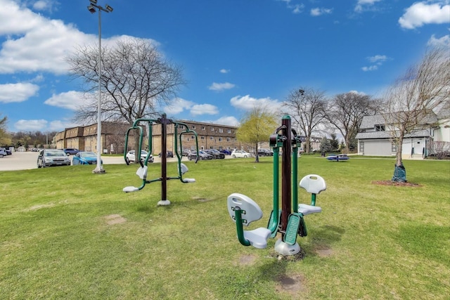 view of property's community with playground community and a lawn