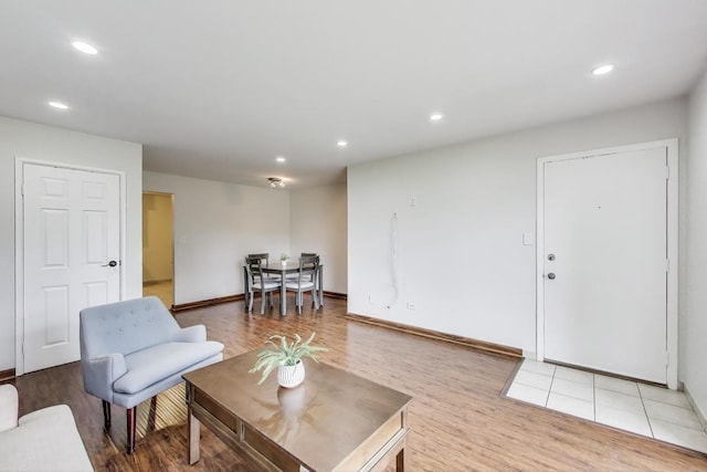 living area with recessed lighting, light wood finished floors, and baseboards