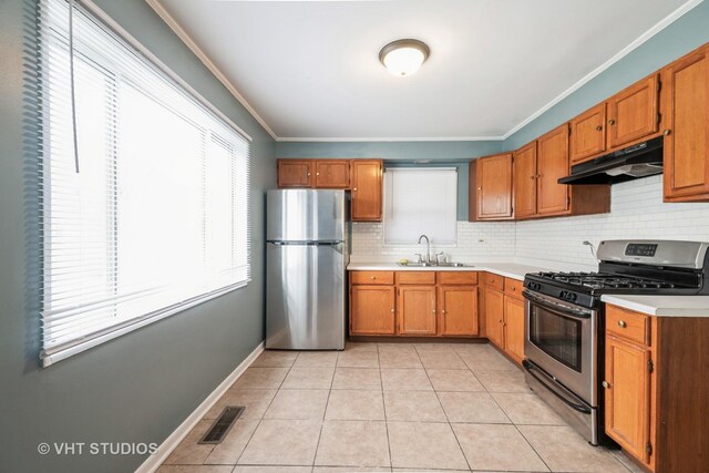 226 Shabbona Dr, Park Forest, IL 60466 - kitchen with visible vents, a sink, light countertops, under cabinet range hood, and stainless steel appliances