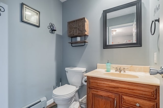 half bathroom with a baseboard radiator, baseboards, toilet, and vanity
