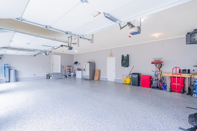 garage featuring a garage door opener and white refrigerator with ice dispenser