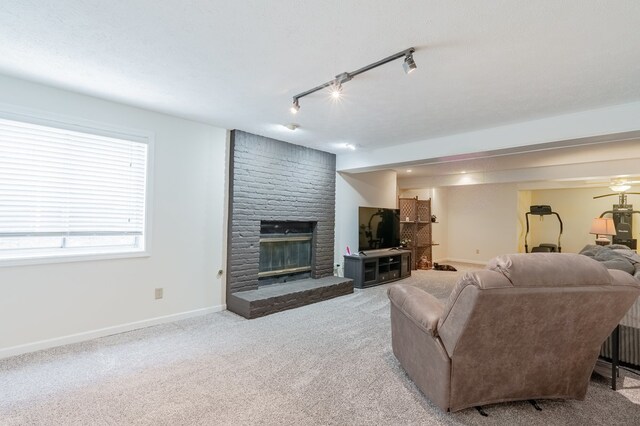 carpeted bedroom with a ceiling fan, baseboards, and a textured ceiling