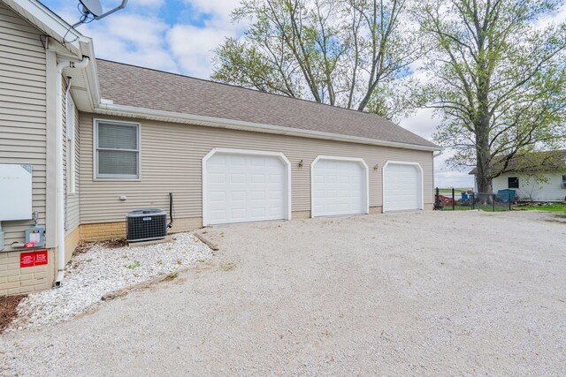 exterior space with central air condition unit, roof mounted solar panels, and dirt driveway