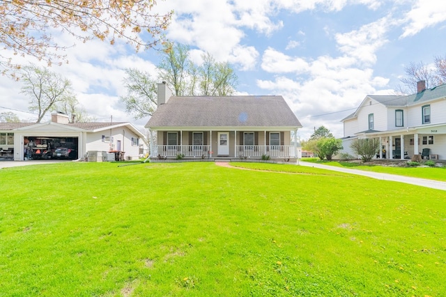 bungalow-style home featuring a porch, an attached garage, driveway, and a front yard
