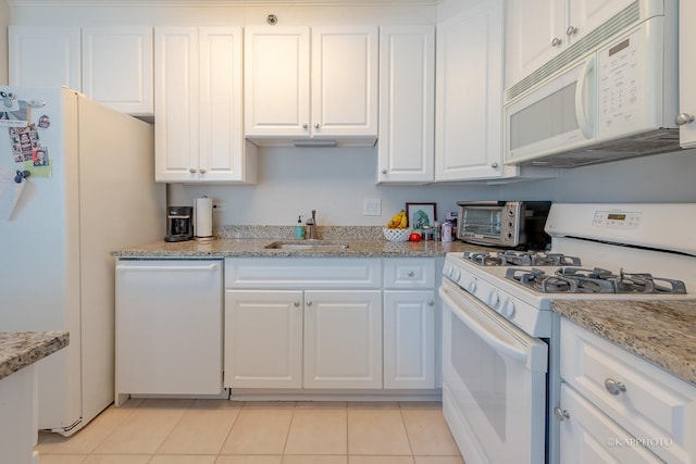 kitchen with a toaster, white appliances, white cabinetry, and a sink