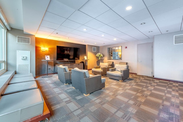 carpeted living room featuring baseboards, visible vents, and recessed lighting
