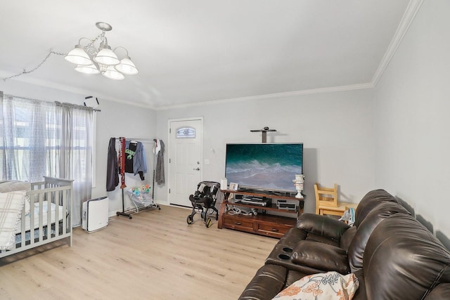 living area featuring baseboards, wood finished floors, a chandelier, and ornamental molding
