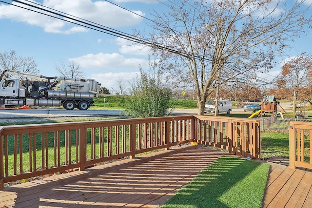 wooden deck featuring a playground