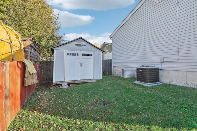 view of shed with a fenced backyard and central air condition unit