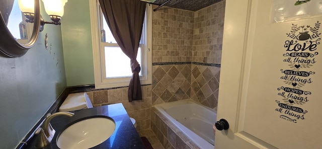 8605 S Dorchester Ave, Chicago, IL 60619 - bathroom with tile walls, a sink, and tiled shower / bath combo