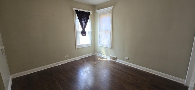 8605 S Dorchester Ave, Chicago, IL 60619 - unfurnished room with baseboards, dark wood finished floors, and visible vents