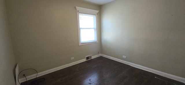 8605 S Dorchester Ave, Chicago, IL 60619 - empty room with visible vents, baseboards, and dark wood finished floors