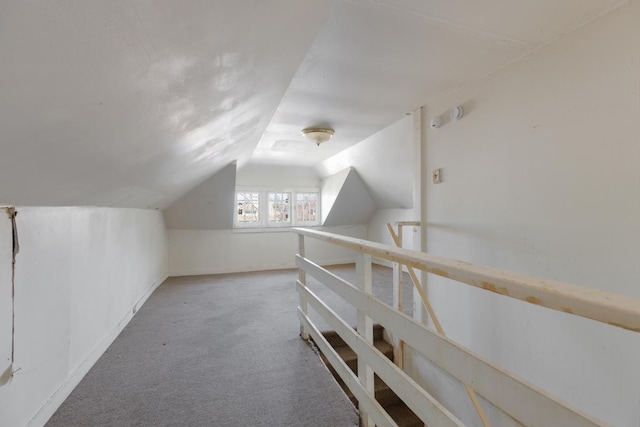 bonus room featuring vaulted ceiling and carpet floors